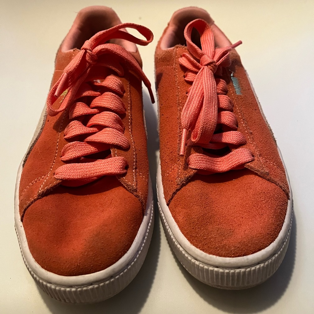 Worn pink pumas